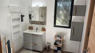 a bathroom with a sink and a mirror at Maison de vacances avec piscine proche mer et montagne in Ghisonaccia