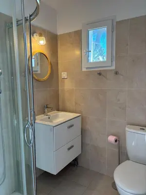 a bathroom with a toilet and a sink and a shower at Appartement 2 personnes bord de mer in Sagone