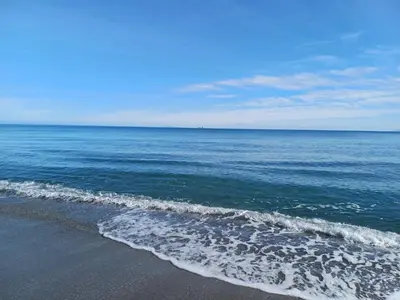 a view of the ocean from the beach at les pivoines in Borgo