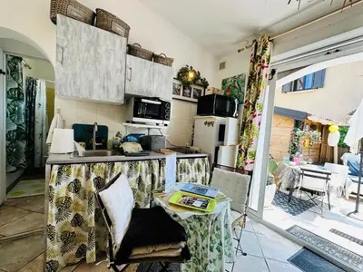 a kitchen with a table and a counter top at les pivoines in Borgo