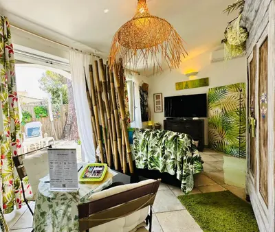 a living room with a couch and a chandelier at les pivoines in Borgo