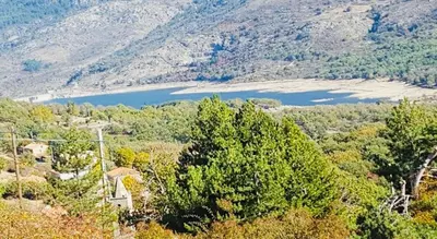 a view of a mountain with trees and a lake at À casetta in Albertacce
