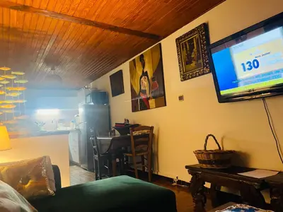 a living room with a flat screen tv on the wall at À casetta in Albertacce