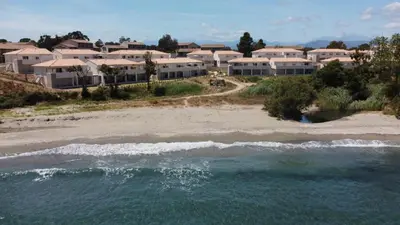 an aerial view of a beach with houses at T3 Corse vue mer. pieds dans l'eau N164 in Linguizzetta