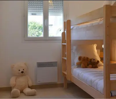 two teddy bears sitting on the floor in a bedroom at T3 Corse vue mer. pieds dans l'eau N164 in Linguizzetta