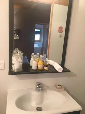 a bathroom sink with a large mirror above it at Chalet in Tasso