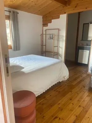 a bedroom with a bed and a wooden floor at Chalet in Tasso