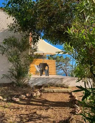 a table and chairs in front of a tent at Appartement bord de mer 2 personnes in Sagone