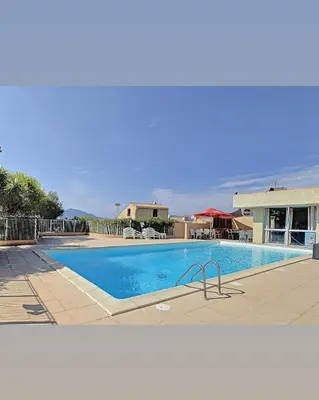 a large swimming pool in a resort at Appartement T2 vue mer in Porticcio