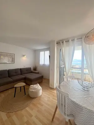 a living room with a couch and a table at Appartement T2 vue mer in Porticcio