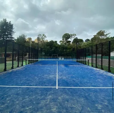 a tennis court with a net on it at Appartement T2 vue mer in Porticcio