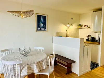 a dining room with a table and a kitchen at Appartement T2 vue mer in Porticcio
