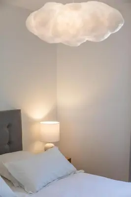 a bedroom with a bed and a cloud light at Résidence Casaviva in Calvi