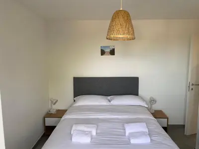 a bedroom with a bed with two towels on it at Appartement 2 pièces dans une résidence hôtelière Les Hameaux de Saint-Cyprien in Lecci