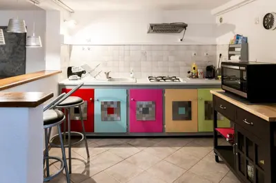 a kitchen with a colorful island in the middle at Bas de villa, Haute-Corse, vue montagne, 5min des plages in Prunelli-di-Fiumorbo