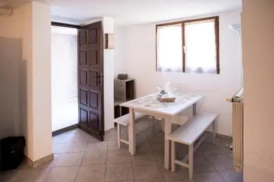 a dining room with a table and a window at Bas de villa, Haute-Corse, vue montagne, 5min des plages in Prunelli-di-Fiumorbo
