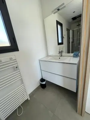 a bathroom with a sink and a mirror at Les Toits de Moriani in San-Nicolao