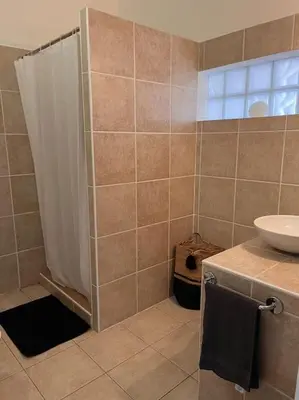 a bathroom with a shower and a sink at Appartement 2 chambres, mezzanine et piscine in Porto-Vecchio