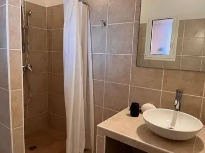 a bathroom with a sink and a shower at Appartement 2 chambres, mezzanine et piscine in Porto-Vecchio