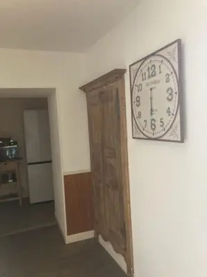 a clock on a wall in a room at Ravissant appartement au cœur de Piana in Piana
