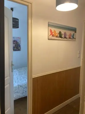 a hallway with a door to a room with a bed at Ravissant appartement au cœur de Piana in Piana