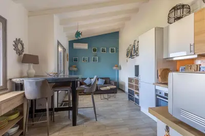 a kitchen and dining room with a table and chairs at Azura Prugna - Maison avec piscine partagée in Grosseto-Prugna
