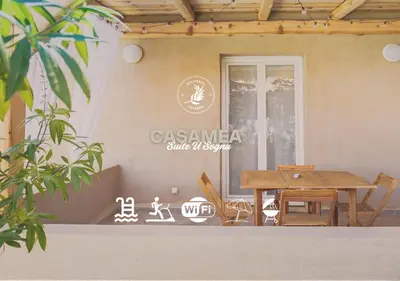 a table and chairs in front of a house at Casamea - Suite U Sognu in Talasani