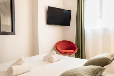 a hotel room with a bed and a red chair at Casamea - Suite U Sognu in Talasani