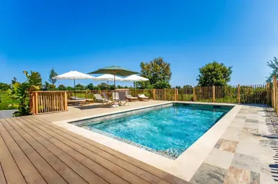 a swimming pool with a wooden deck and an infinity at Casamea - Suite U Sognu in Talasani