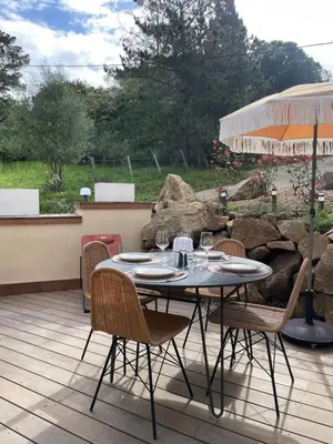 a table and chairs sitting on a patio at Caseddu 100m de la plage in Belvédère