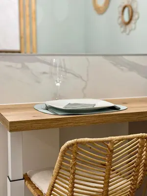 a table with a plate and a glass of wine at Le cocon du Roi Jérôme - Hypercentre in Ajaccio