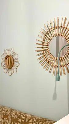 a mirror hanging on a wall next to a couch at Le cocon du Roi Jérôme - Hypercentre in Ajaccio