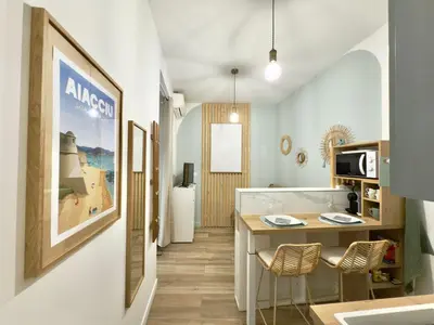 a kitchen with a table and chairs in a room at Le cocon du Roi Jérôme - Hypercentre in Ajaccio