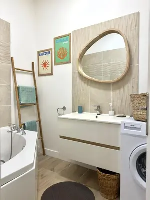 a bathroom with a sink and a mirror at Le cocon du Roi Jérôme - Hypercentre in Ajaccio
