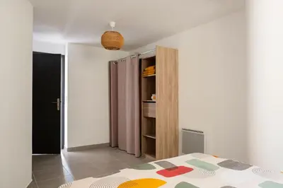 a bedroom with a bed and a book shelf at Appartement départ GR20 in Calenzana