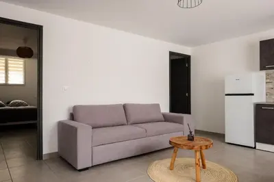 a living room with a couch and a table at Appartement départ GR20 in Calenzana