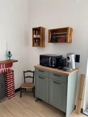 a kitchen with a counter with a microwave on it at T2 Paisible et cosy in Sollacaro