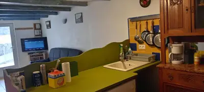 a kitchen with a green counter top and a sink at NIOLU in Albertacce