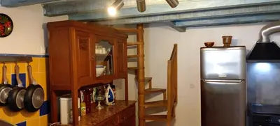 a kitchen with a refrigerator and a wooden cabinet at NIOLU in Albertacce