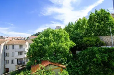 a group of trees in front of a building at Casamea - Famille, 2 chambres, Centre , Calme in Ajaccio