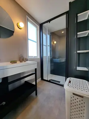 a bathroom with a shower and a white sink at Chalet n * 1 au cœur du maquis in Bonifacio