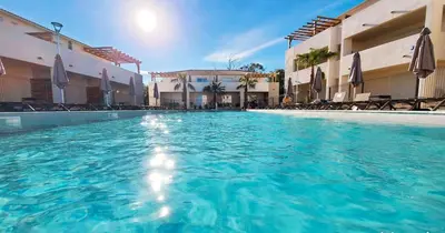 a swimming pool with blue water in a hotel at Bravone 74- piscine en résidence-clim-wifi-pieds dans l'eau in Linguizzetta