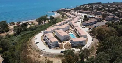 an aerial view of a resort next to the ocean at Bravone 74- piscine en résidence-clim-wifi-pieds dans l'eau in Linguizzetta