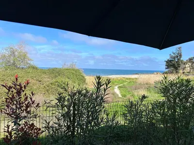 a view of the beach from a house at Bravone 74- piscine en résidence-clim-wifi-pieds dans l'eau in Linguizzetta