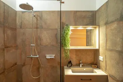 a bathroom with a sink and a shower with a mirror at I Carbonni - Bergerie 80m2 entre mer et montagne in Sotta