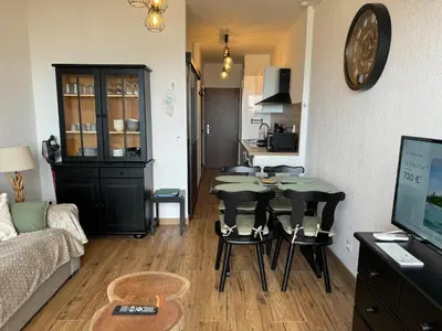 a living room with a table and a couch at Appartement n 302 moriani plage in Moriani Plage