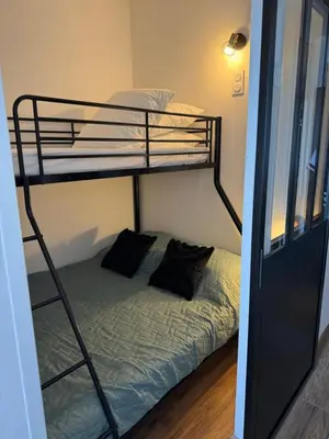 a room with two bunk beds and a bed at Appartement n 302 moriani plage in Moriani Plage