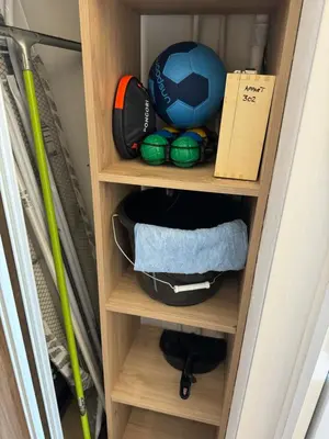 a cupboard with a soccer ball and balls in it at Appartement n 302 moriani plage in Moriani Plage