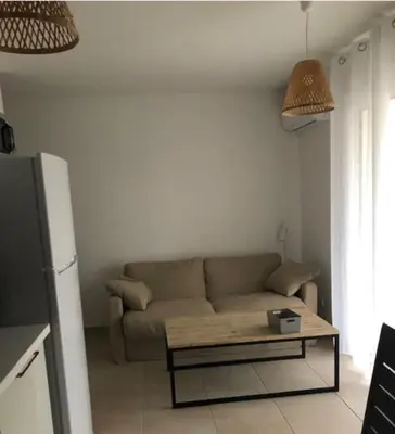 a living room with a couch and a coffee table at Appart. en Corse t3 bord de mer et piscine. N 143 in Linguizzetta