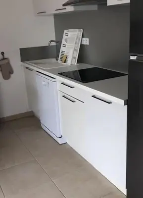 a kitchen with a white counter and a sink at Appart. en Corse t3 bord de mer et piscine. N 143 in Linguizzetta